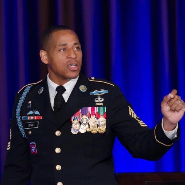 Cedric King speaking in dress blues
