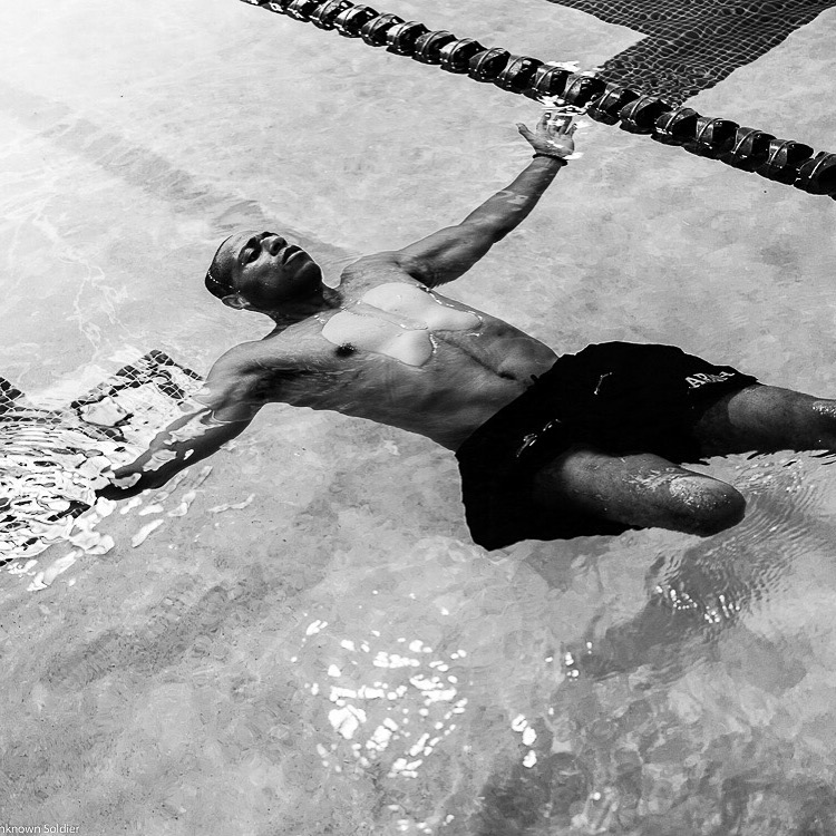 Cedric King floating in a rehabilitation pool